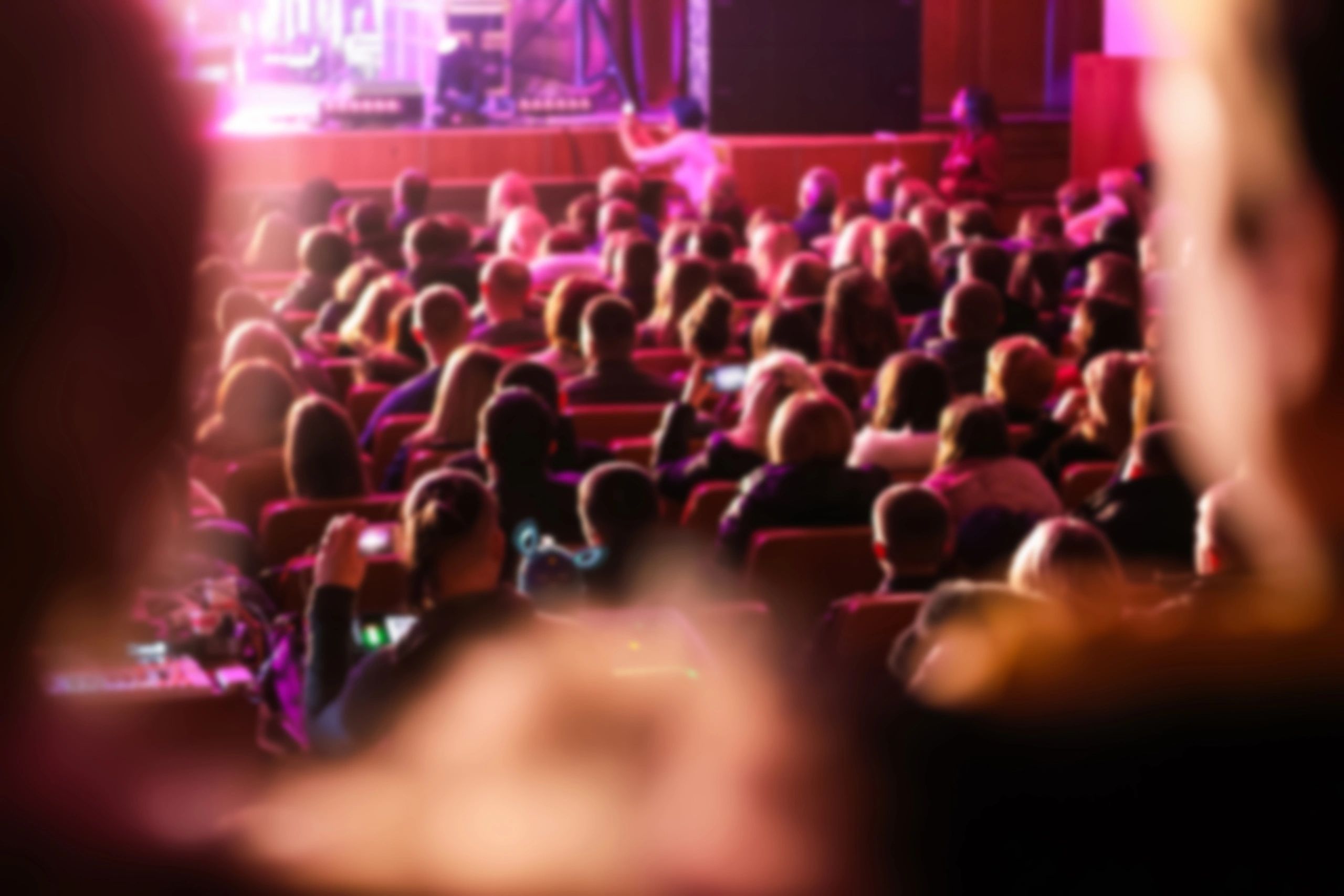 Large audience seated in an auditorium